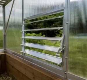 ClimaPod Louver Window installed at the base of a greenhouse
