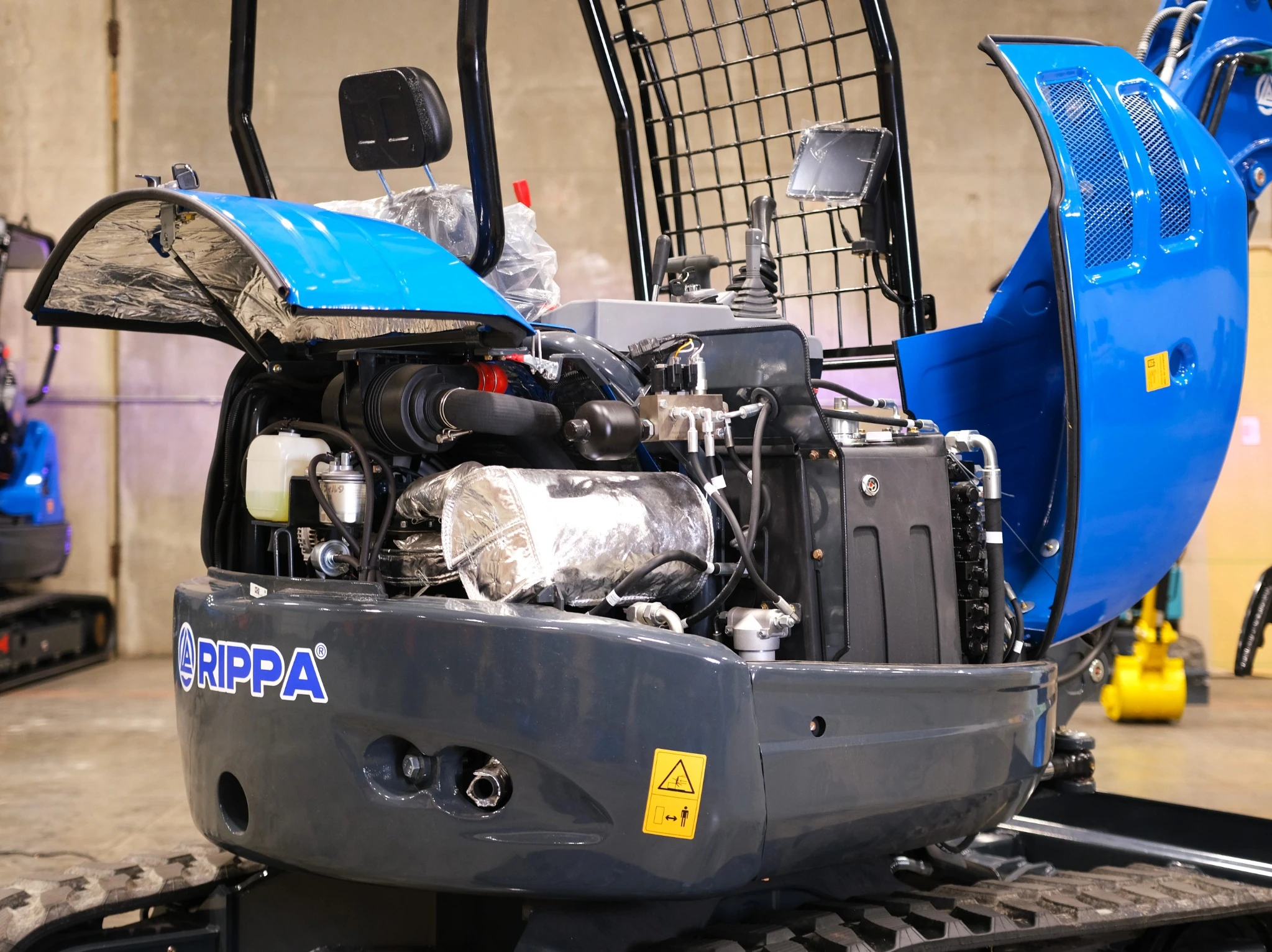Open engine bay of the R32 Pro showing Kubota V1505 and insulation.