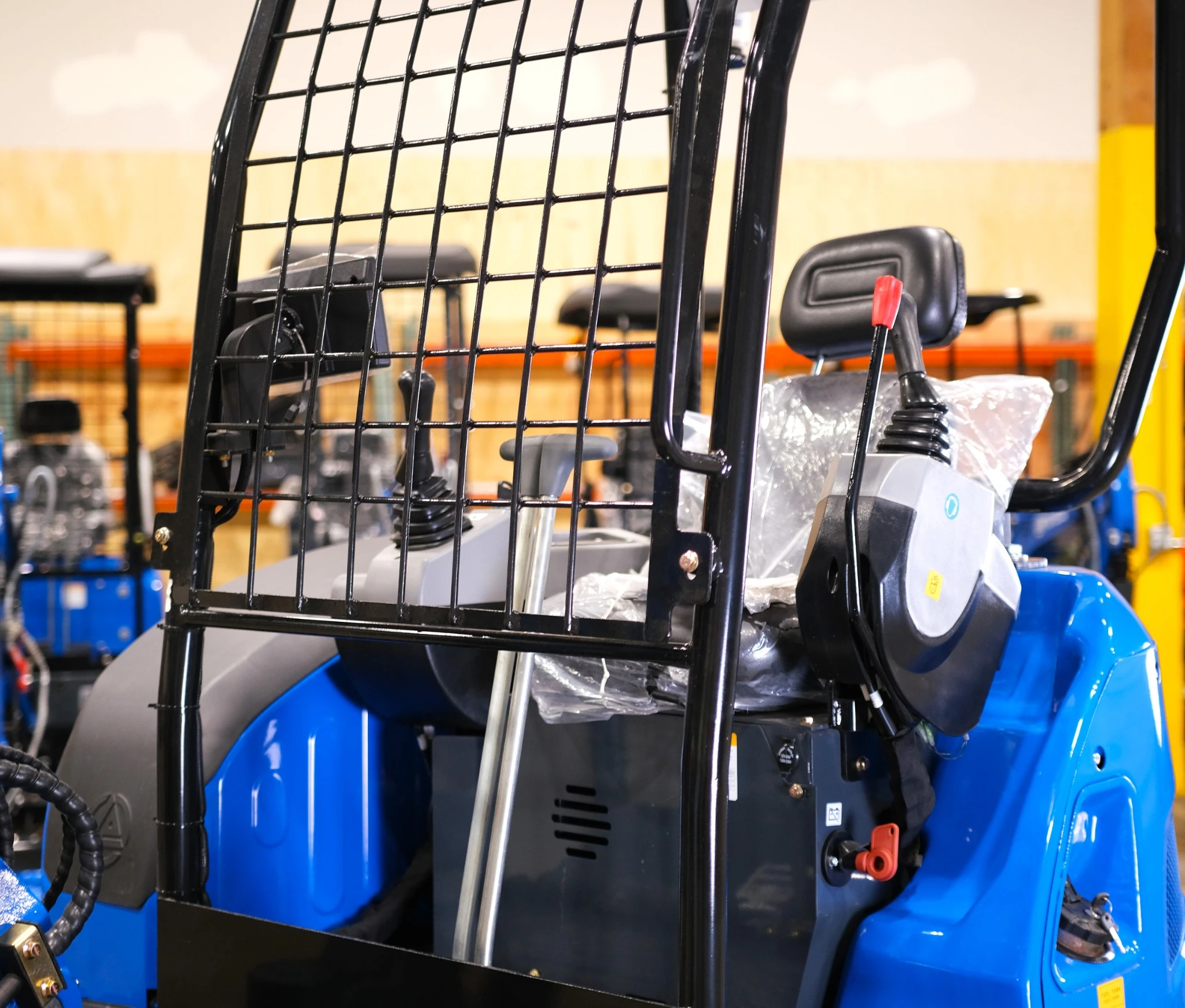 Operator area with protective front grid and controls.