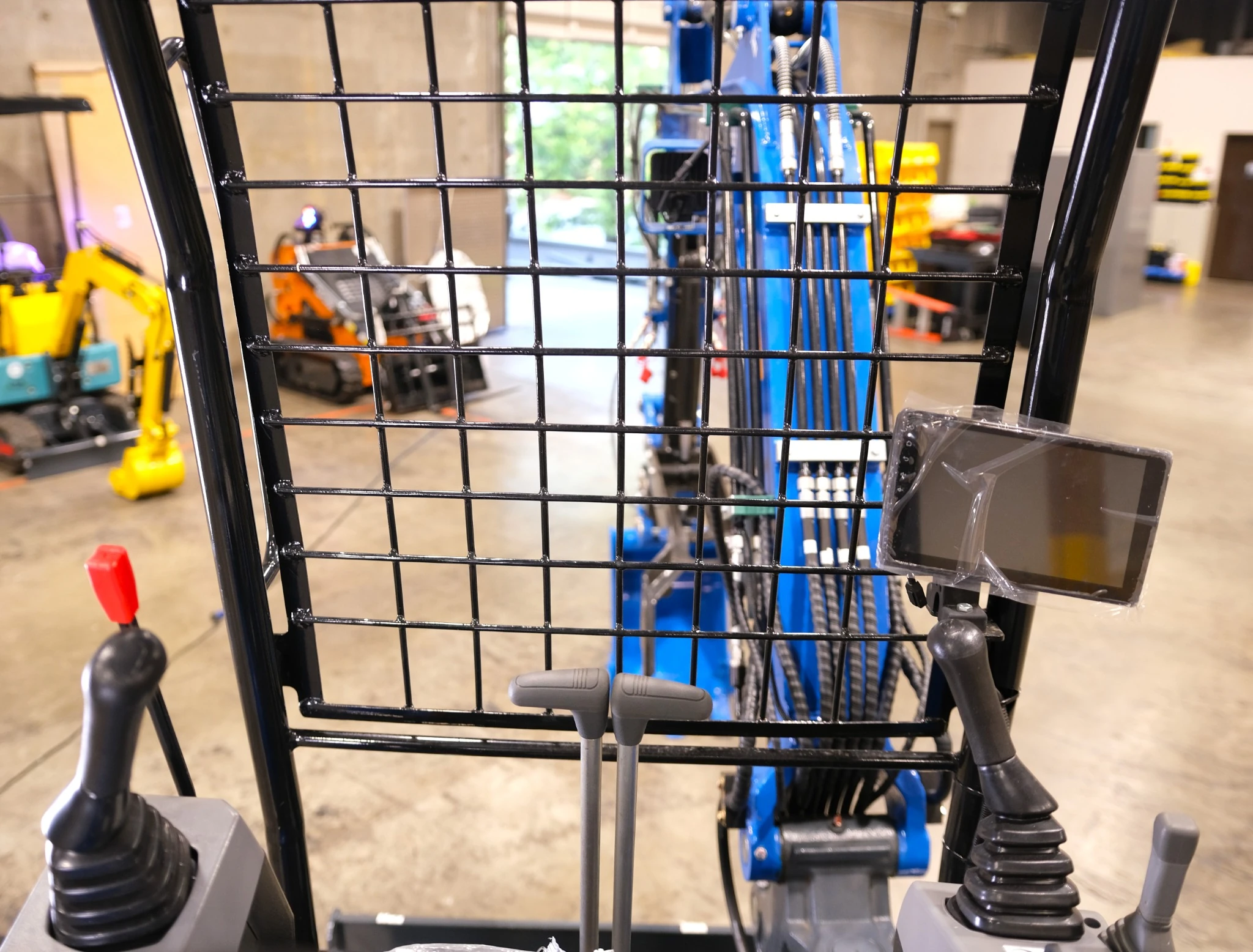 Operator area with protective front grid and controls.