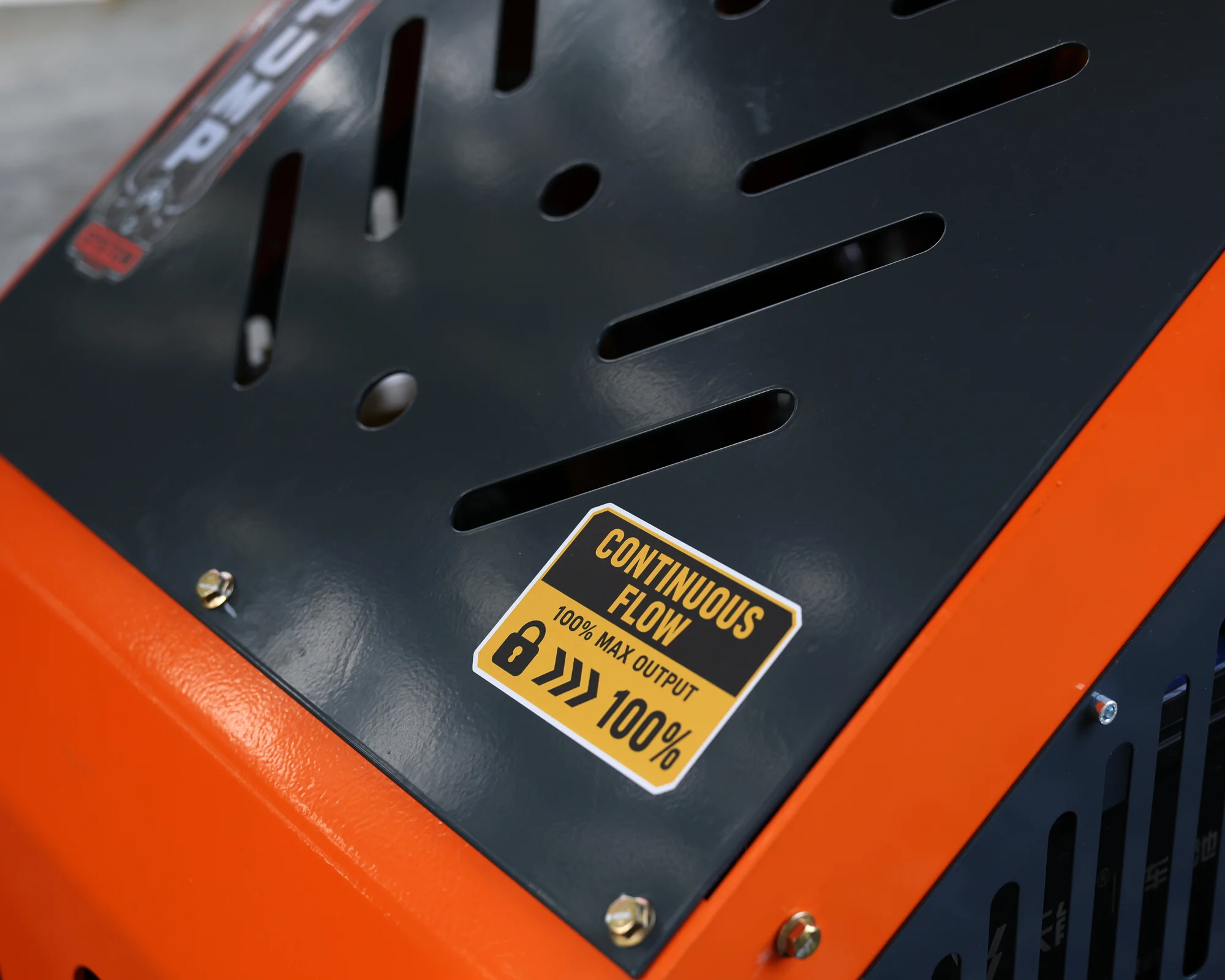 Dig Master DM24 orange mini skid steer: constant flow hydraulics detail