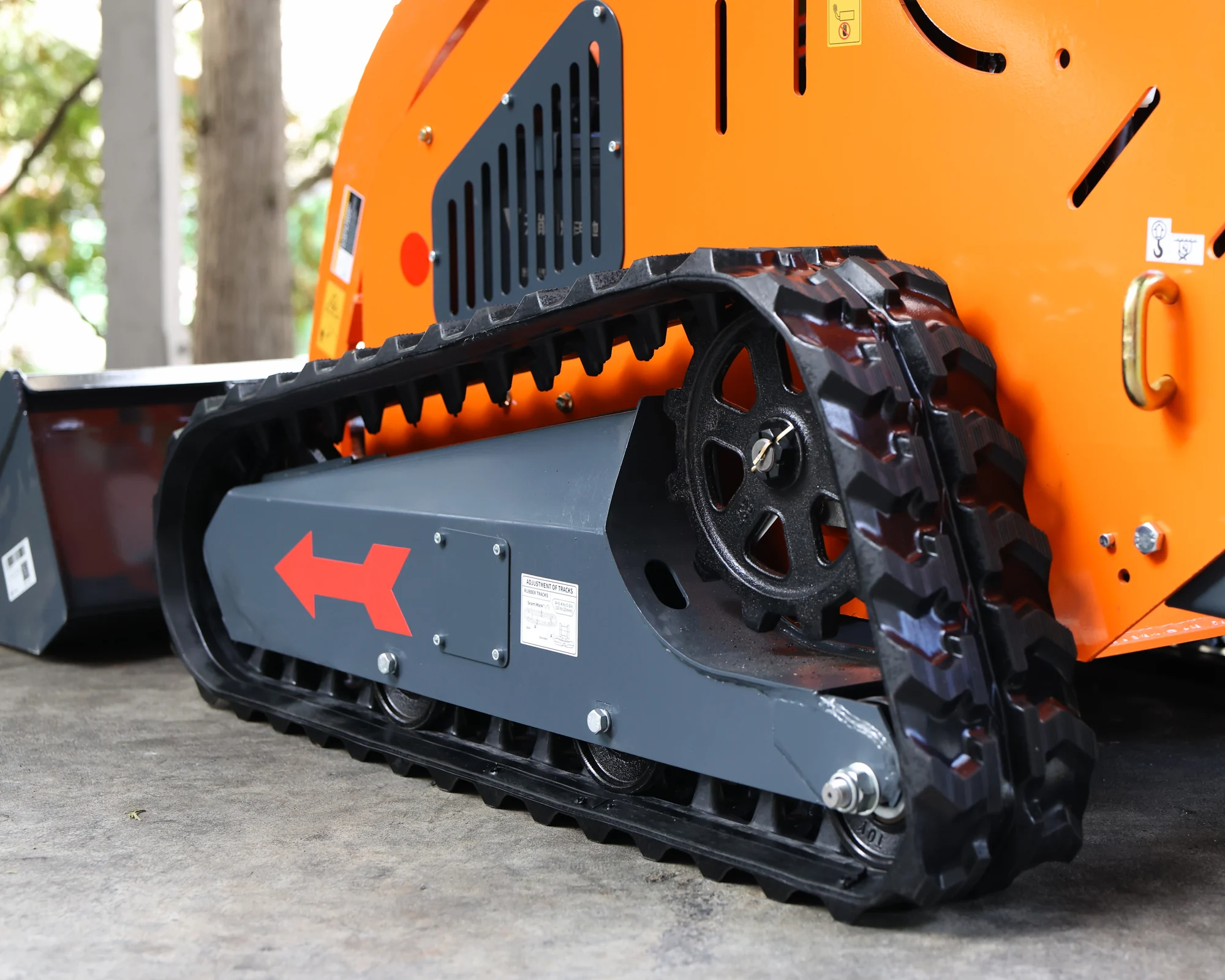 Dig Master DM24 orange mini skid steer: rubber tracked undercarriage