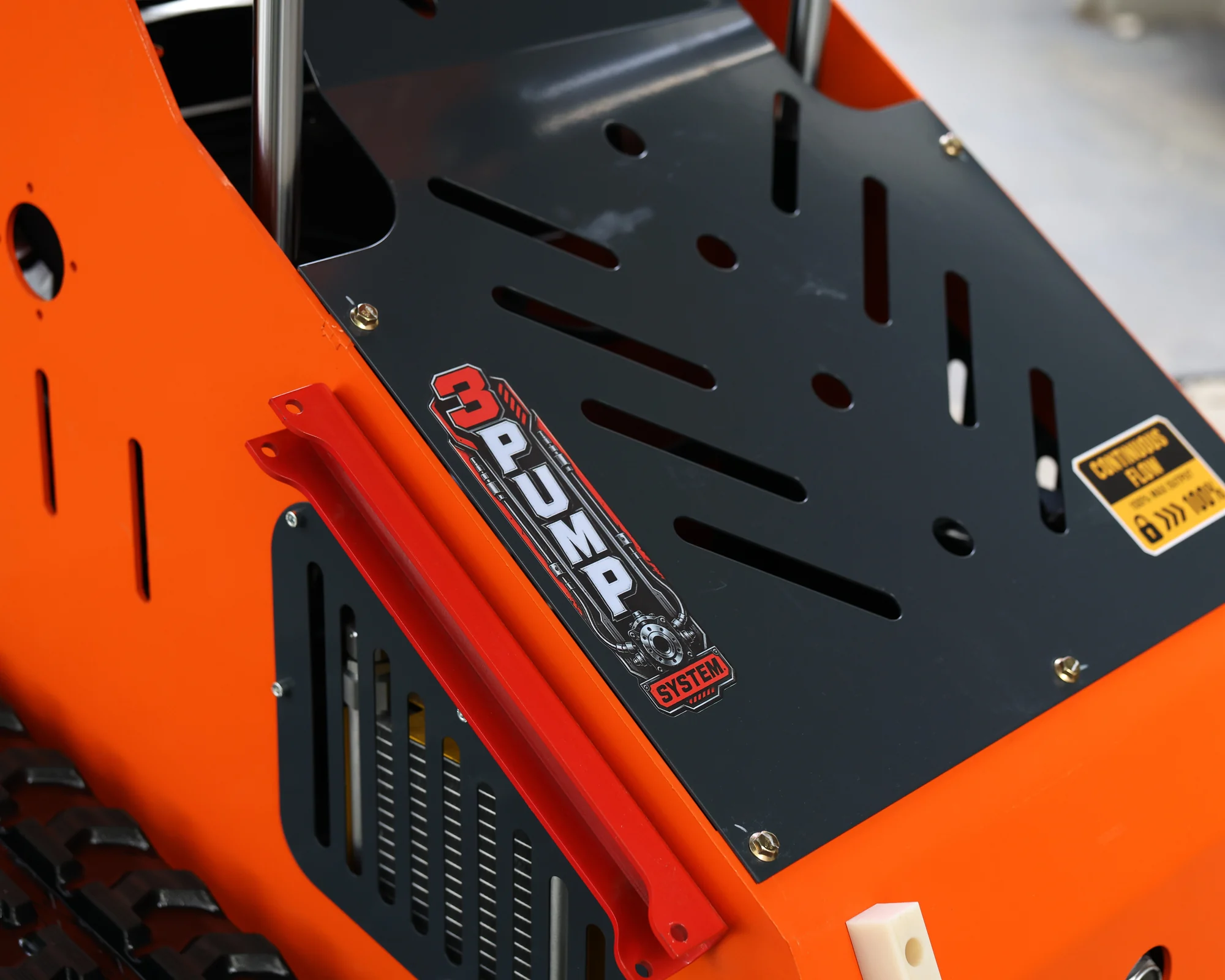Dig Master DM24 orange mini skid steer: triple pump system detail